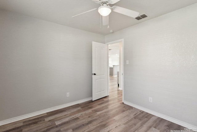 spare room featuring hardwood / wood-style flooring and ceiling fan