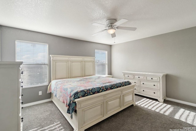 bedroom with ceiling fan, carpet, and a textured ceiling