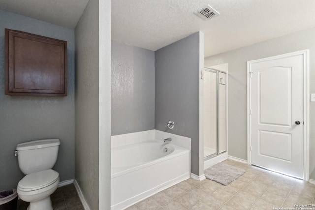 bathroom featuring separate shower and tub, toilet, and a textured ceiling