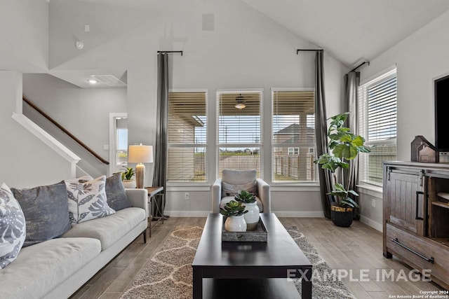 living room with light hardwood / wood-style flooring and lofted ceiling