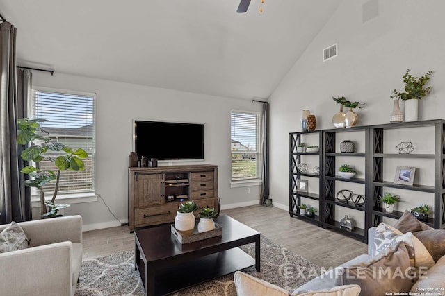 living room with light wood-type flooring, ceiling fan, and lofted ceiling