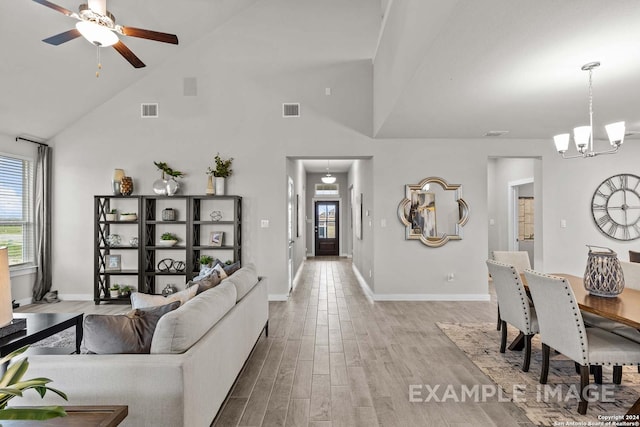 living room featuring ceiling fan with notable chandelier, high vaulted ceiling, and light hardwood / wood-style flooring