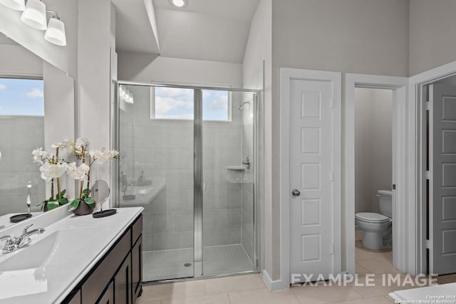 bathroom with tile patterned floors, vanity, a shower with shower door, and toilet