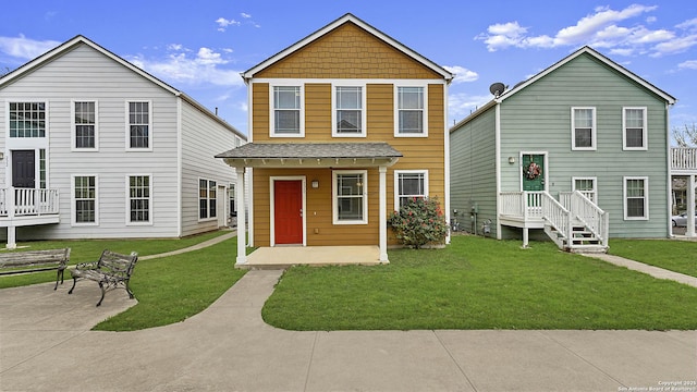 front of property featuring a front lawn and a patio area