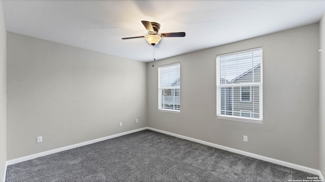 empty room featuring dark colored carpet and ceiling fan