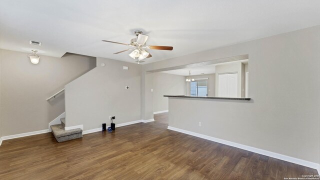 unfurnished living room with dark hardwood / wood-style floors and ceiling fan