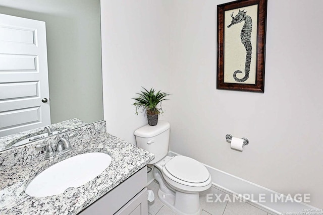 bathroom featuring toilet, vanity, and tile patterned floors