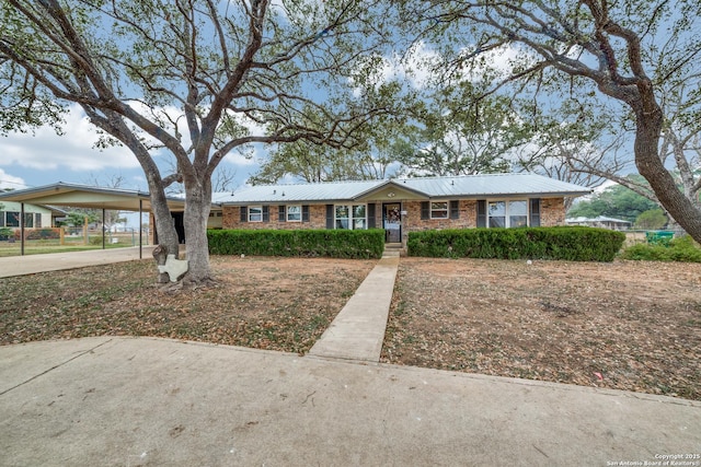 ranch-style home featuring a carport