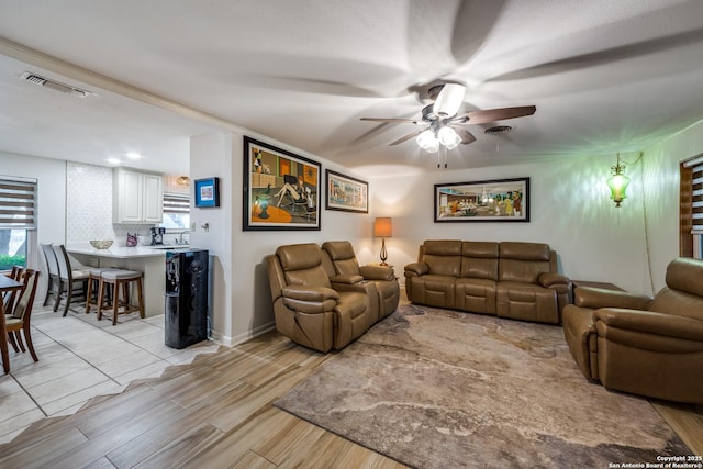 living room with ceiling fan and light hardwood / wood-style floors