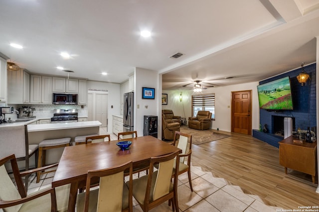 dining area featuring light wood-type flooring and ceiling fan