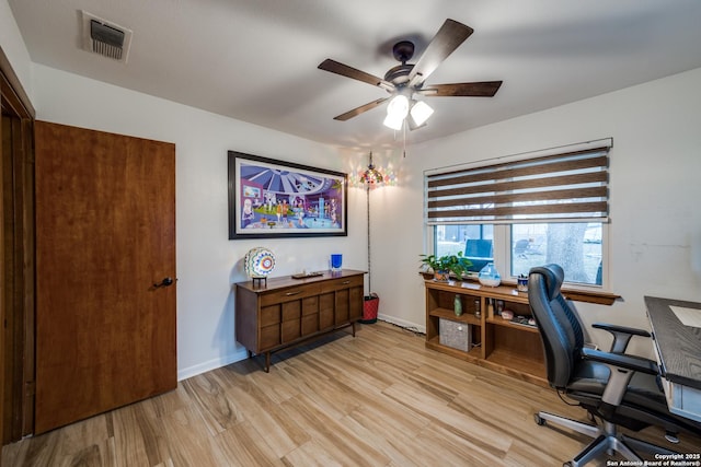 home office with ceiling fan and light hardwood / wood-style floors