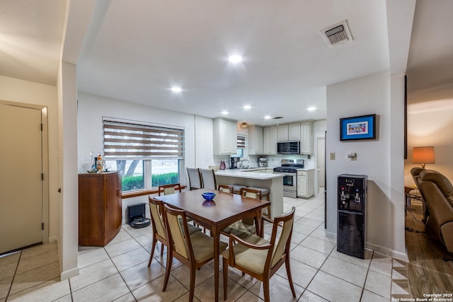 dining area featuring light tile patterned floors and sink