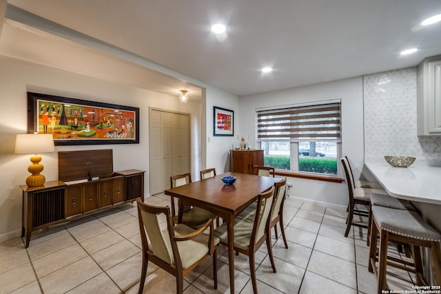 dining space featuring light tile patterned flooring