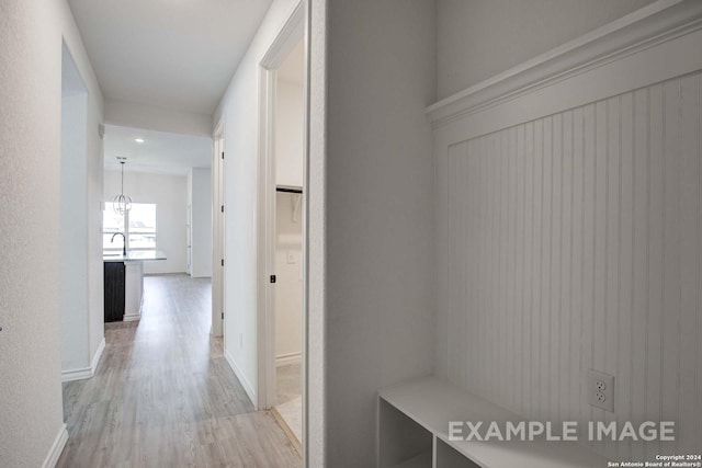 corridor featuring light hardwood / wood-style flooring and sink