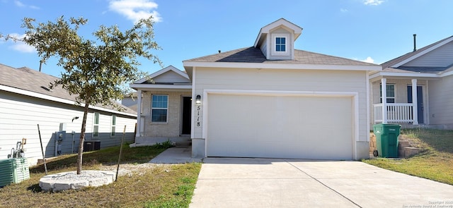 view of front of home with a front lawn, a garage, and cooling unit