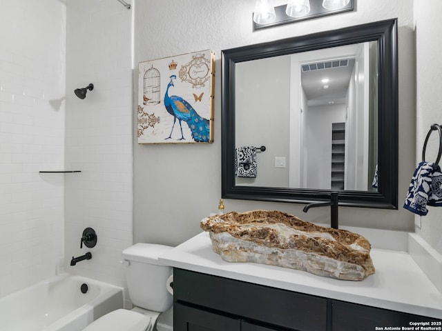 full bathroom with toilet, vanity, and tiled shower / bath