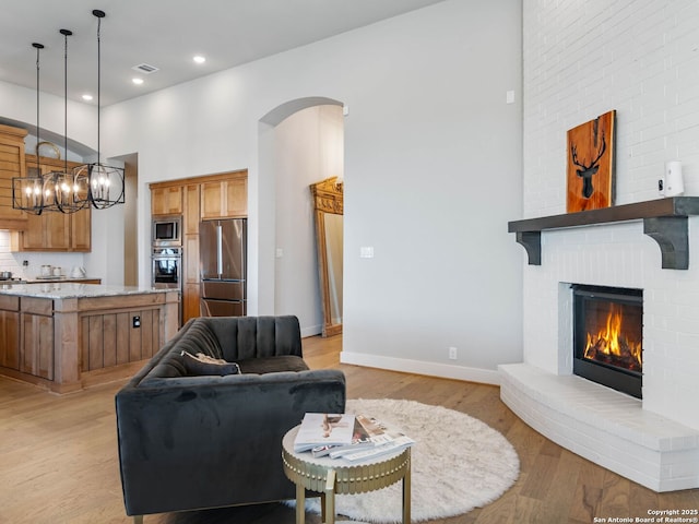 living room with light hardwood / wood-style floors and a fireplace