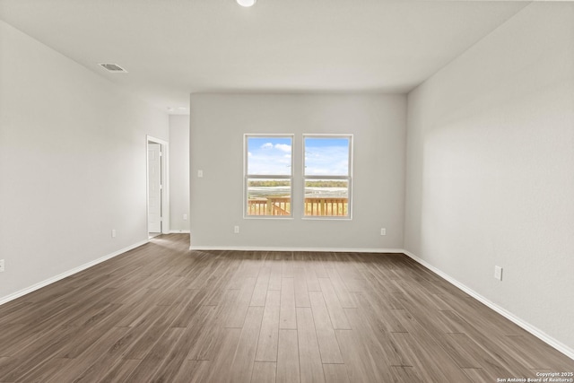 empty room featuring wood-type flooring