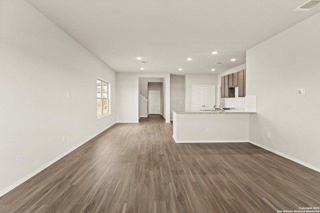 unfurnished living room featuring dark wood-type flooring