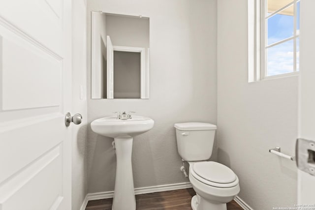 bathroom featuring hardwood / wood-style flooring and toilet