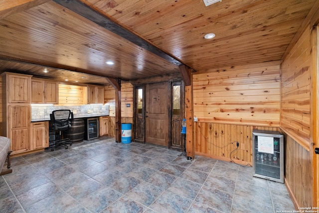 unfurnished office featuring wood walls, beverage cooler, and wooden ceiling