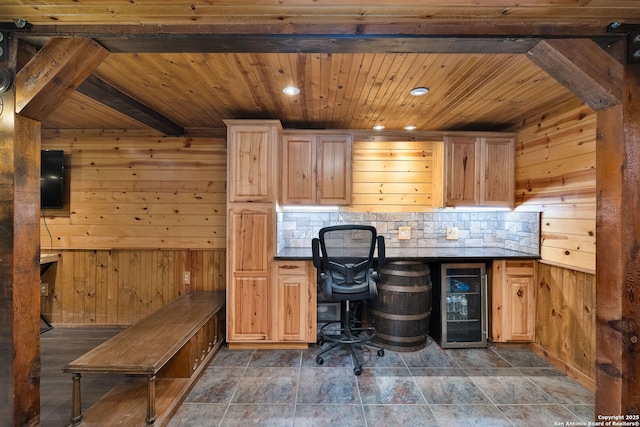 unfurnished office featuring beverage cooler, wooden walls, wooden ceiling, beamed ceiling, and bar