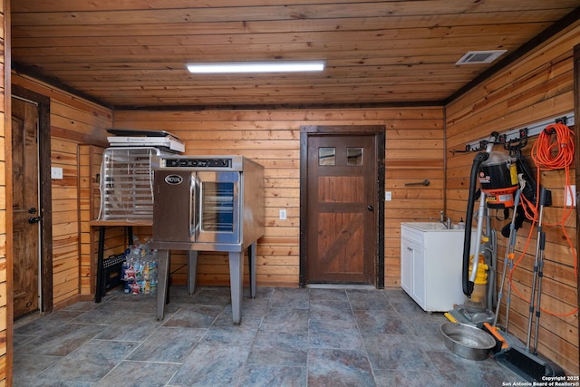 interior space with wood walls and wooden ceiling