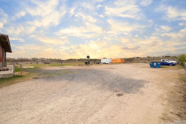 yard at dusk with a rural view