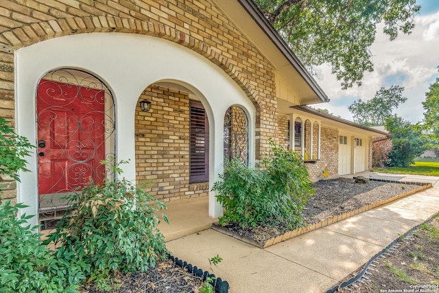 view of exterior entry featuring a garage