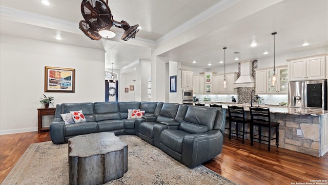 living room featuring ornamental molding and dark wood-type flooring