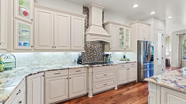 kitchen featuring white cabinetry, dark wood-type flooring, stainless steel refrigerator with ice dispenser, and custom exhaust hood