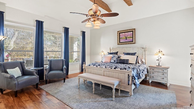 bedroom with beam ceiling, ceiling fan, and dark wood-type flooring