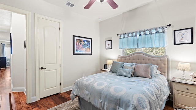 bedroom with ceiling fan and dark wood-type flooring