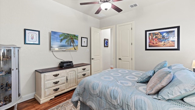 bedroom with ceiling fan and dark wood-type flooring