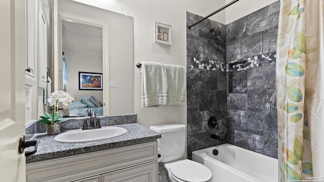 full bathroom featuring vanity, shower / tub combo, and toilet