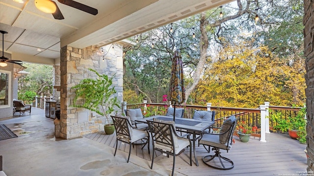 wooden deck featuring ceiling fan