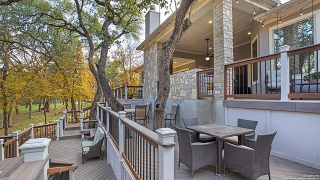 wooden deck featuring ceiling fan