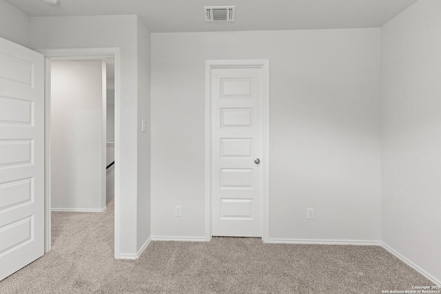 unfurnished room with light carpet