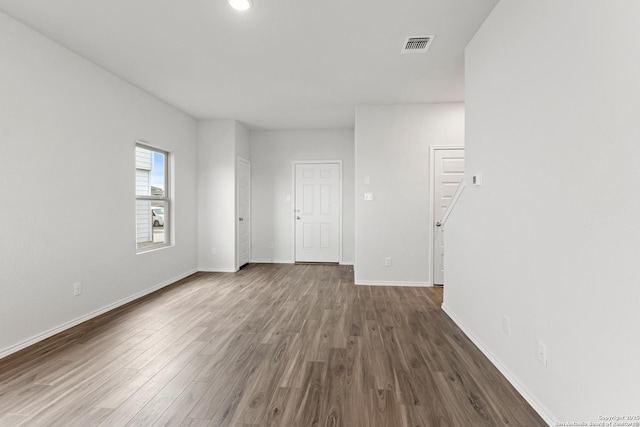 empty room with dark hardwood / wood-style flooring