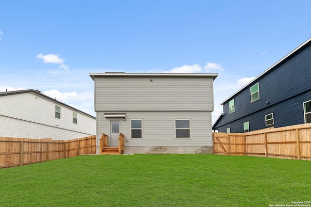 rear view of house with a lawn