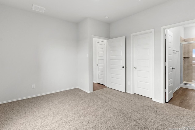 unfurnished bedroom with a closet and carpet floors