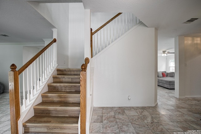 stairway with ceiling fan