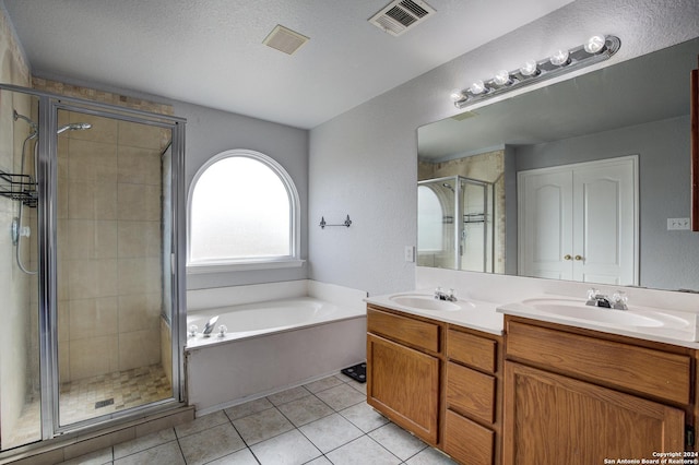 bathroom featuring tile patterned flooring, vanity, and separate shower and tub