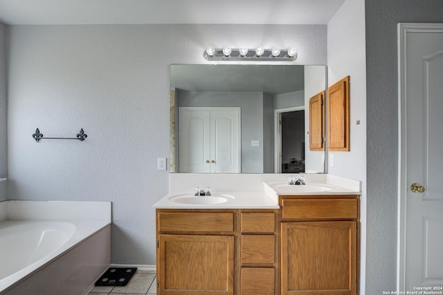 bathroom featuring tile patterned flooring, vanity, and a bathtub