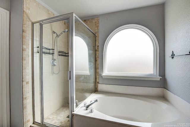 bathroom featuring separate shower and tub