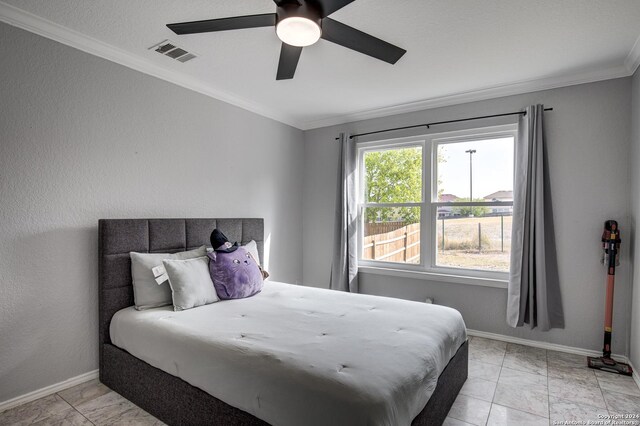 bedroom with ceiling fan and ornamental molding