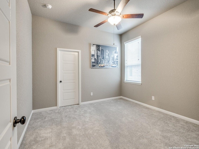 carpeted empty room featuring ceiling fan