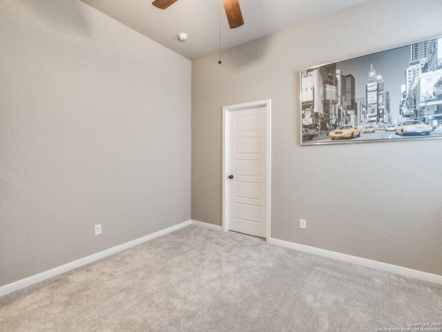 empty room featuring lofted ceiling and carpet floors