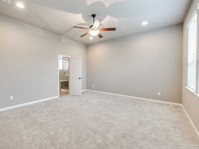 carpeted spare room with ceiling fan