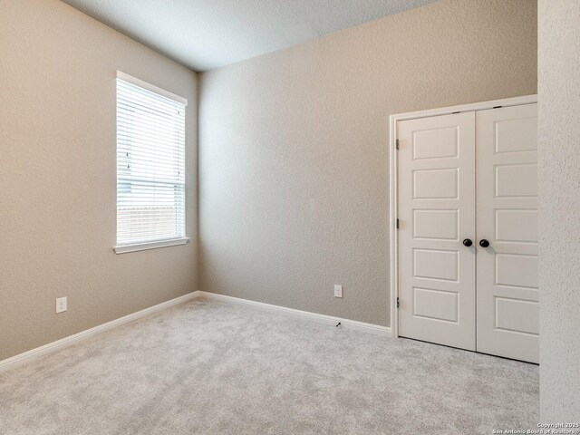 carpeted spare room with a wealth of natural light